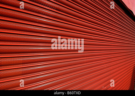 red metal shutter security door on a shop front Stock Photo