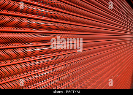 red metal shutter security door on a shop front Stock Photo