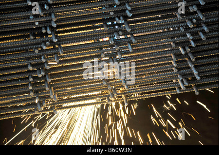 Cutting steel reinforcing mesh with a cutting torch Stock Photo