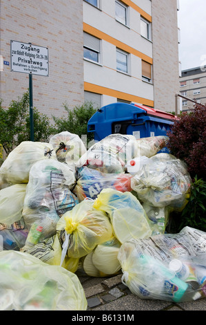 Recycling in Germany, yellow bags and waste paper in front of apartment blocks