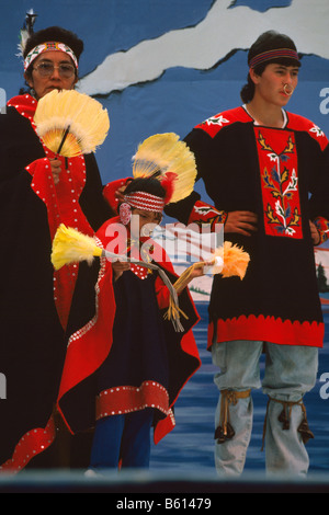 Native American Tlingit Indian Family celebrating at a Pow Wow in Traditional Ceremonial Regalia Dress Stock Photo