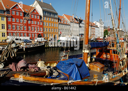 Historic boats in front of a row of apartment houses in the Nyhavn, Copenhagen, Denmark, Scandinavia, Europe Stock Photo