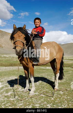 Kazakh, Mongolian boy sitting on horse, Kazakhstan, Mongolia, Asia Stock Photo