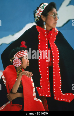 Native American Tlingit Indian Mother and Daughter celebrating at a Pow Wow in Traditional Ceremonial Regalia Dress Stock Photo