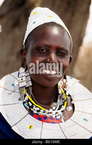 Young Massai woman with typical headdress in Kiloki village, Serengeti, Tanzania, Africa Stock Photo