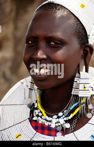 Young Massai woman with typical headdress in Kiloki village, Serengeti, Tanzania, Africa Stock Photo