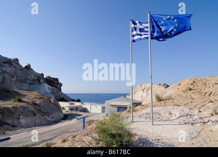 European and Greek flag, symbolic for the EU supported project, seawater desalination plant on Milos, Cyclades, Greece, Europe Stock Photo