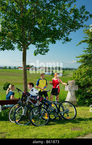 Cyclists having a break at the Plattenberg Mountain, County of Altoetting, Upper Bavaria Stock Photo