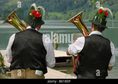 Horn players of the Niklasreuth brassband wearing traditional costumes at the Alt-Schliersee churchday, Lake Schliersee Stock Photo