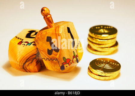 Jewish Dreidels Dreydles with Hanukkah Chanukah chocolate gold coins gelt Childs Game Stock Photo