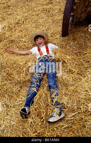 Child playing in the hay, Kutztown Folk Festival, Pennsylvania, USA Stock Photo