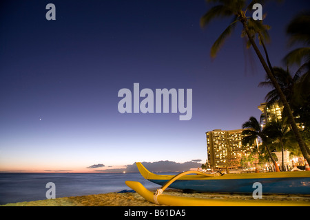 A outrigger canoe on Waikiki beach in Honolulu, Oahu, Hawaii at dusk. Stock Photo