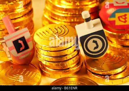 Jewish Dreidels Dreydles with Hanukkah Chanukah chocolate gold coins gelt Childs Game Stock Photo