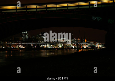 View of the River Thames at Millennium Bridge and Southwark Bridge from under Blackfriars Railway Bridge, London Stock Photo