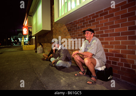Banana pickers wait in the early hours of the morning for the bus to take them to the plantation Stock Photo