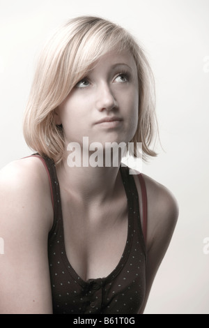 Blond girl, 15, looking up Stock Photo