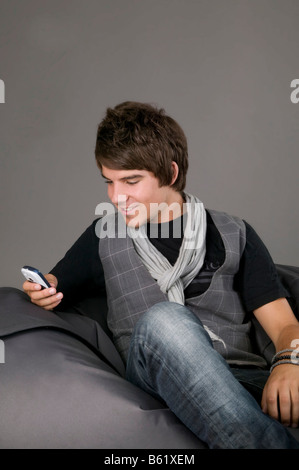 Young man using his mobile phone Stock Photo