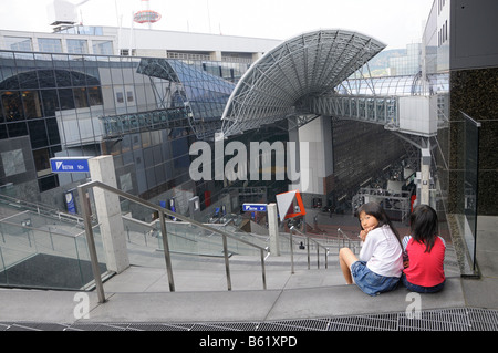 Japanese school children looking down from the 7th floor of the postmodern Kyoto Train Station, Kansai, Japan, Asia Stock Photo