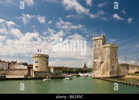 The towers of La Chaine and St Nicholas at the entrance to the ancient port of La Rochelle Charente Maritime France Stock Photo