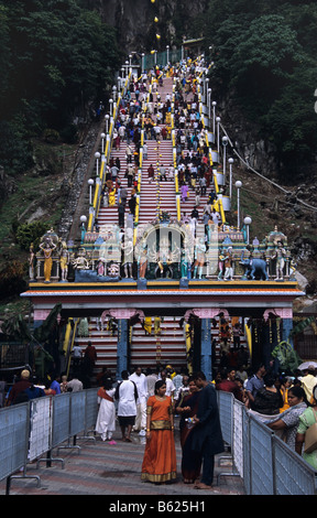 Hindu devotees climb the 272 steps up to the revered Batu Caves, near Kuala Lumpur, Malaysia Stock Photo