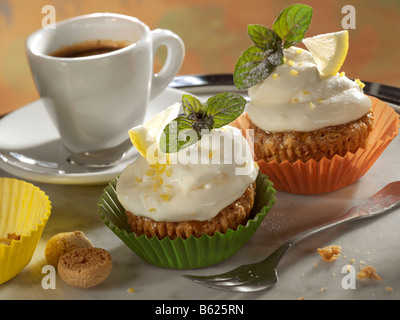 Amarettini-Muffins with cream cheese and a cup of coffee Stock Photo