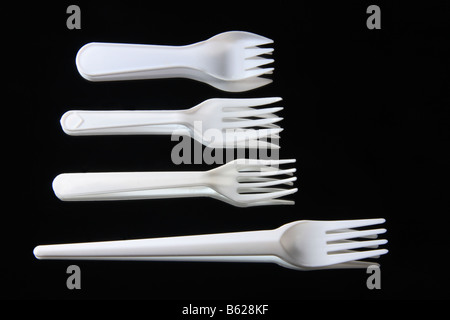 "Plastic Forks" on a "black mirror background". Stock Photo