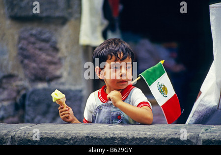 Boy holding an ice cream and a Mexican flag during the national holiday in Mexico City, Mexico, North America Stock Photo