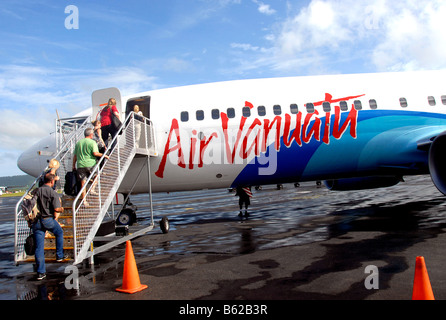 Passengers climbing in Boeing 737 at Bauerfield international airport, Port Vila, Efate island, Vanuatu Stock Photo