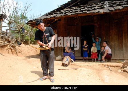 Hmong musician playing the flut in the village, a traditional instrument, Phakeo, Xieng Khuang Province, Laos, Southeast Asia Stock Photo