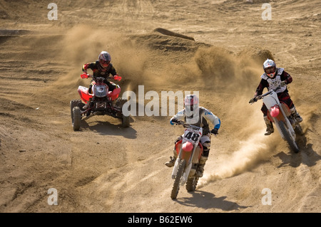 Motorcross and Quad riders sweeping through a bend at Glen Helen circuit Devore California Stock Photo