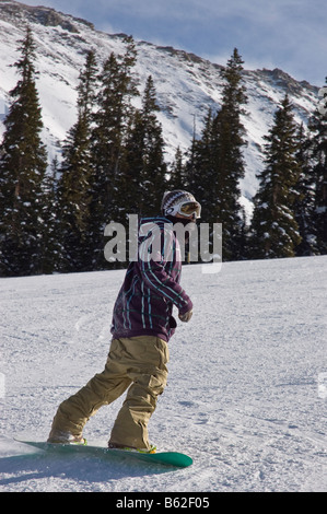 Snowboarder negotiates one of the lower runs, Arapahoe Basin Ski Area, Summit County, Colorado. Stock Photo