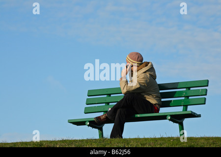 Young man talking on cellphone on sunny autumn day Victoria British Columbia Canada Stock Photo