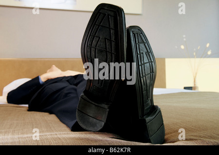 Businessman sleeping on the bed Stock Photo