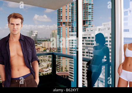Young couple standing in a balcony Stock Photo