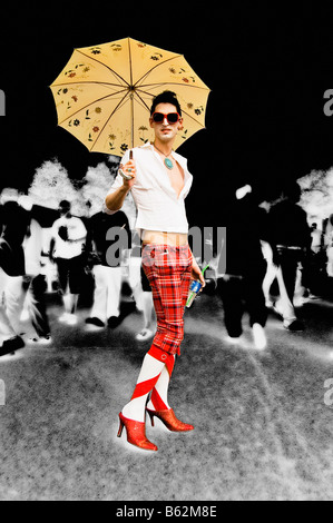 Gay man holding an umbrella and smiling Stock Photo