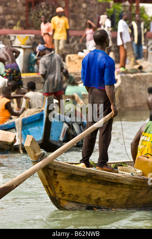 Traditional fishing come into the harbor at Elmina, Ghana after a day of fishing. Stock Photo