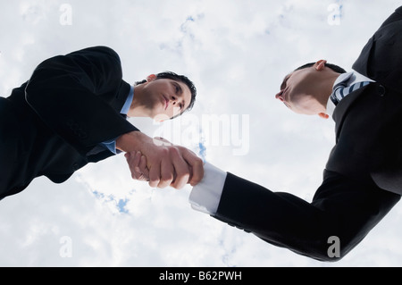 Low angle view of two businessmen shaking hands Stock Photo