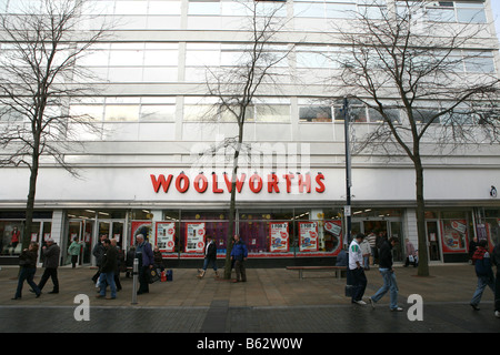 Xmas shoppers walk past Swansea city centre Woolworths highstreet store on day company collapse administration announced Stock Photo