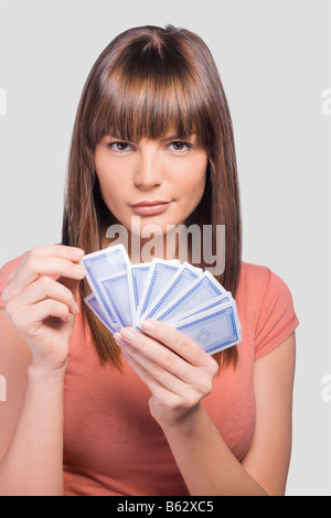 Close-up of a young woman playing cards Stock Photo