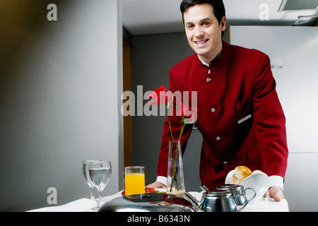 Portrait of a waiter pushing the trolley of breakfast Stock Photo