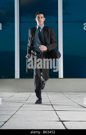 Businessman running in the corridor of an office Stock Photo