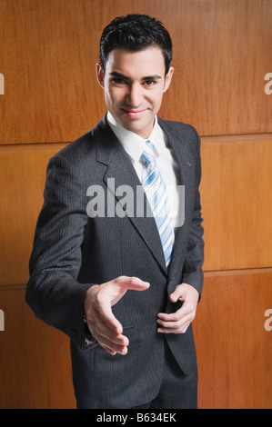 Portrait of a businessman offering for handshake and smiling Stock Photo