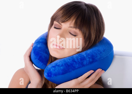 Close-up of a young woman using a neck pillow and sleeping Stock Photo