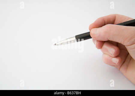 Studio Close up right hand holding a roller ball pen Stock Photo