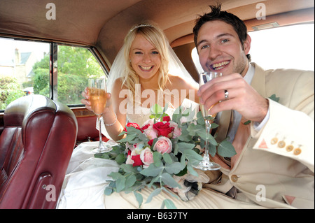 Newly wed couple inside their special car. Stock Photo