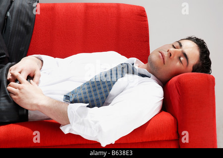 Close-up of a businessman sleeping on a couch Stock Photo