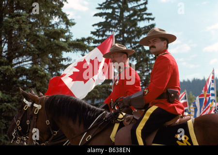 Canadian Mounties (RCMP) Royal Canadian Mounted Police Officers on Horseback and wearing Traditional Red Surge Uniforms Stock Photo