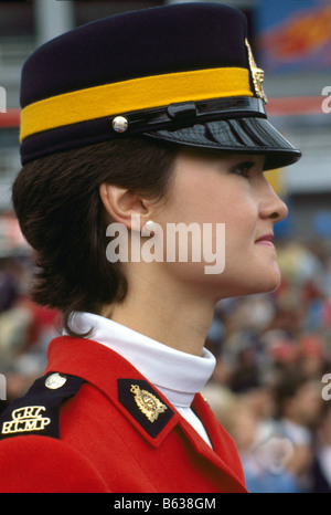 A Canadian Mountie (RCMP) Royal Canadian Mounted Police Officer wearing Traditional Red Surge Uniform and standing at Attention Stock Photo