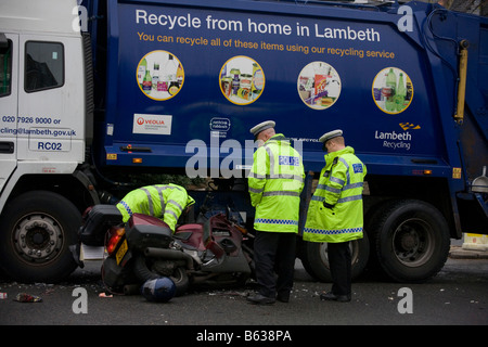 Metropolitan traffic Police investigate the collision between a motorbike and a London borough of Lambeth recycling vehicle Stock Photo