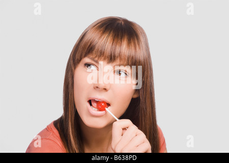 Close-up of a young woman eating a lollipop Stock Photo